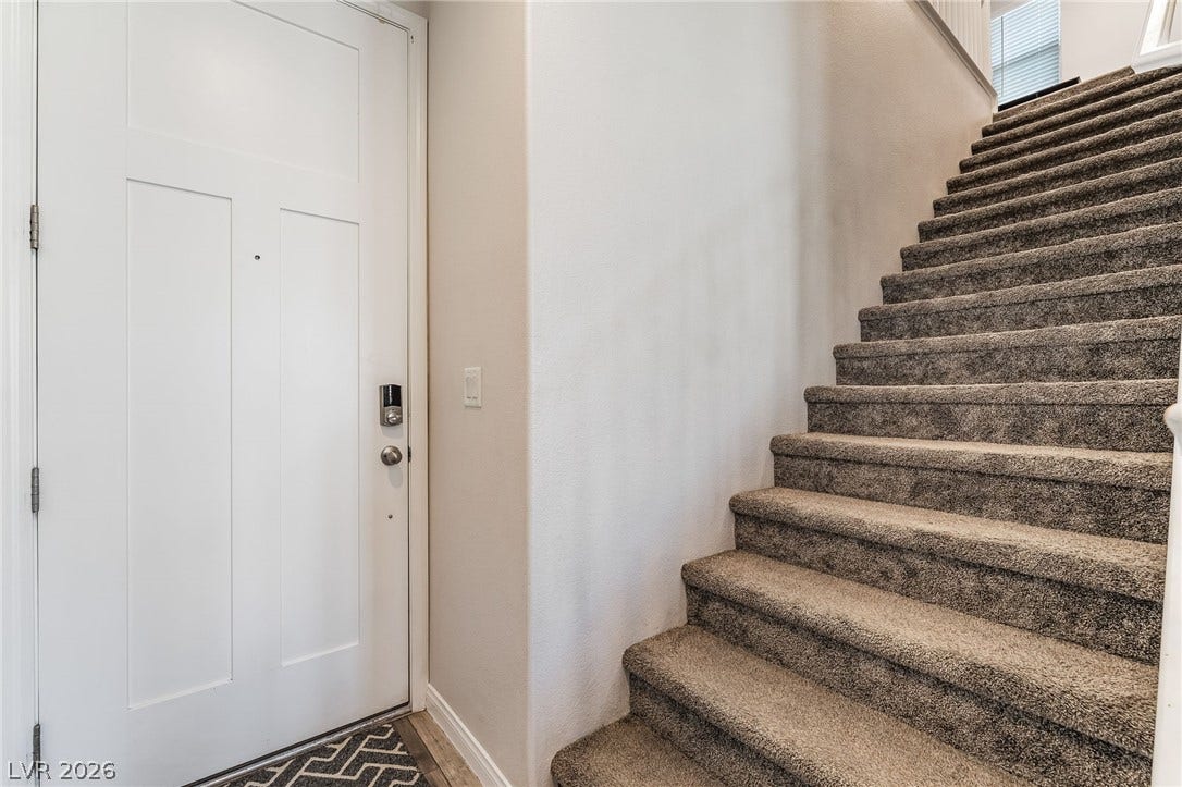 360 Misterioso Street, Henderson, NV 89011 The welcoming entrance features a well-maintained staircase, offering a seamless flow to the upper levels.