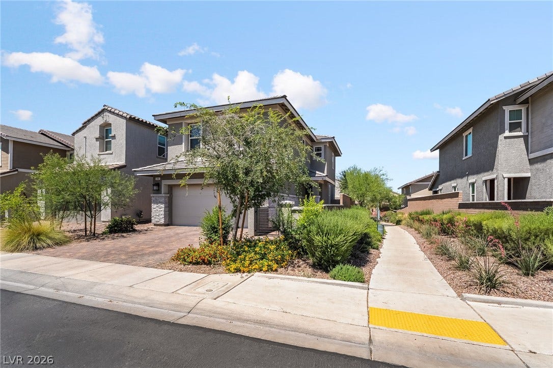 360 Misterioso Street, Henderson, NV 89011 This residence features a paved driveway and well-maintained landscaping, providing a welcoming curbside appeal.