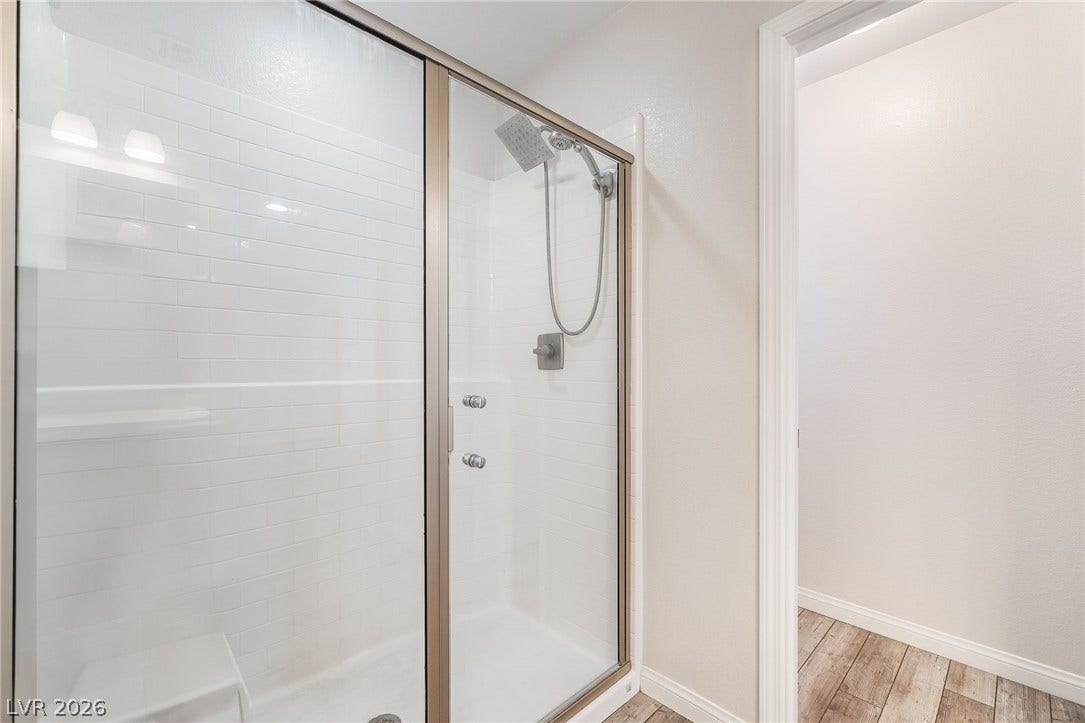 360 Misterioso Street, Henderson, NV 89011 This sleek shower features modern fixtures and an integrated bench for ultimate comfort.