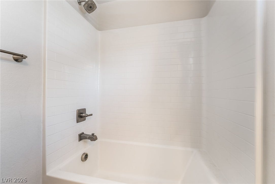 360 Misterioso Street, Henderson, NV 89011 This sleek bathroom features a classic subway tile shower surround.