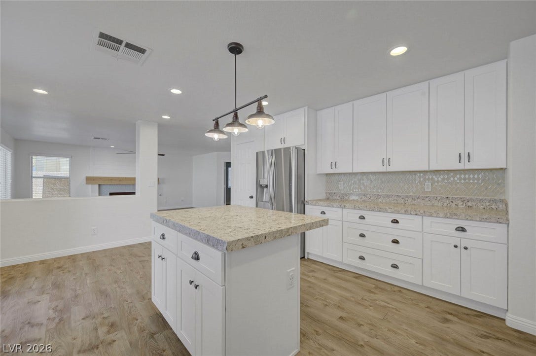 31 Antero Drive, Henderson, NV 89074 A well-lit kitchen presents a functional island and extensive cabinetry, perfect for culinary endeavors.