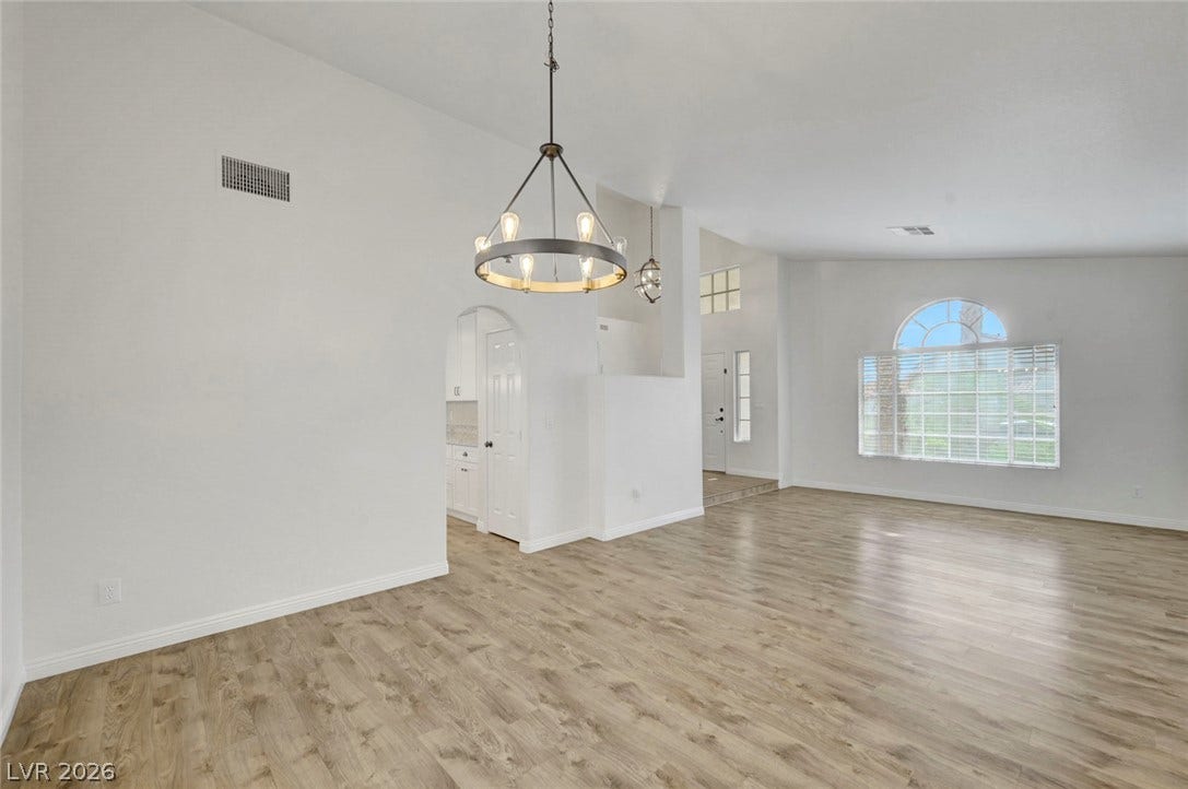 31 Antero Drive, Henderson, NV 89074 An open floorplan with durable laminate flooring and a graceful arched window.