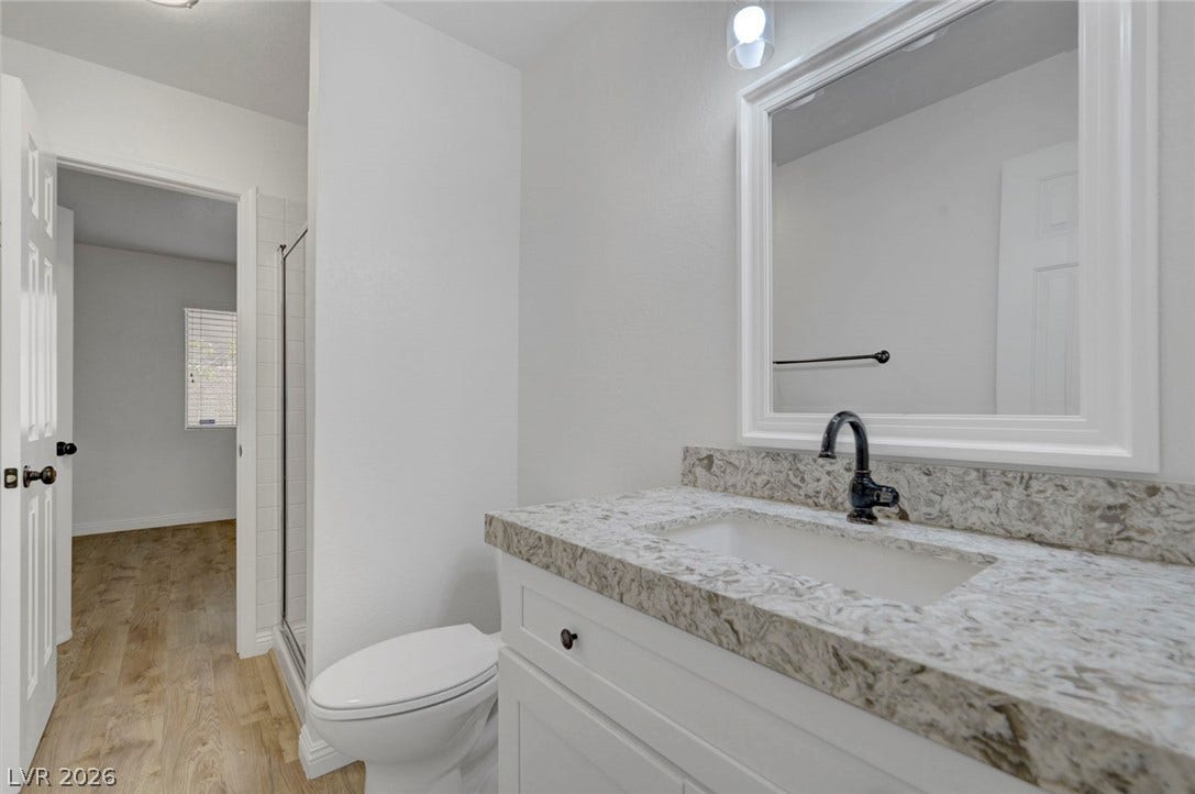 31 Antero Drive, Henderson, NV 89074 A refined bathroom featuring a contemporary vanity with a sleek granite countertop and modern fixtures.