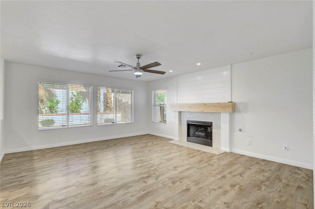 31 Antero Drive, Henderson, NV 89074 A refined living space showcases durable wood flooring and an elegant fireplace for comfort.