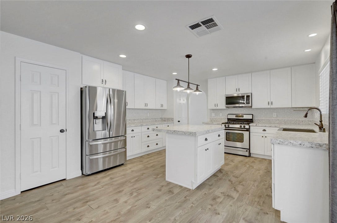31 Antero Drive, Henderson, NV 89074 A pristine culinary space features sleek stainless steel appliances, abundant cabinetry, and a central island.