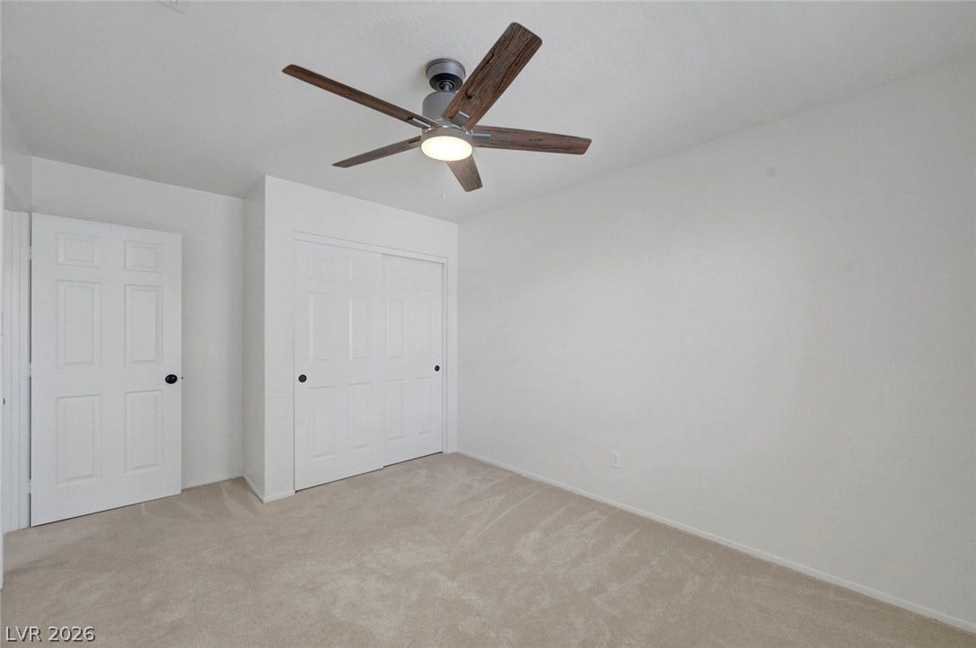 31 Antero Drive, Henderson, NV 89074 An inviting bedroom features soft carpeting and a contemporary ceiling fan for year-round comfort.