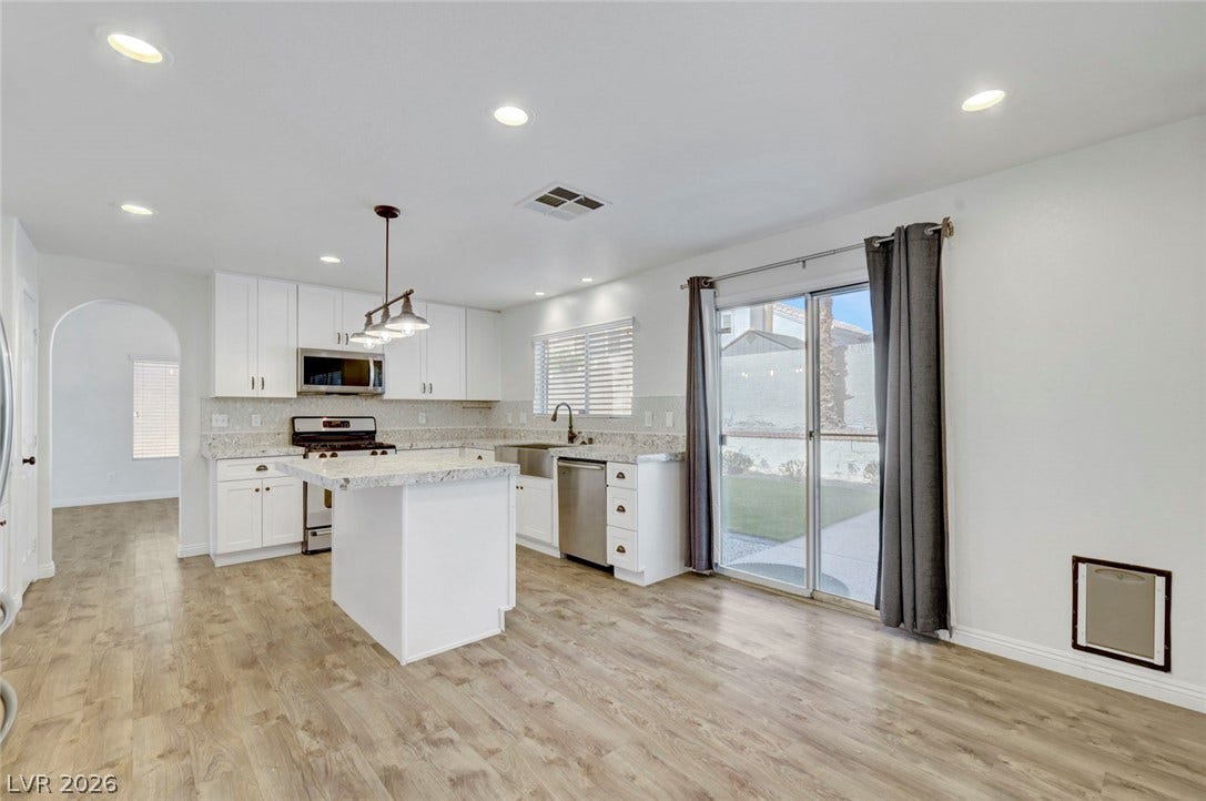 31 Antero Drive, Henderson, NV 89074 Culinary aspirations find a home in this well-appointed kitchen featuring granite countertops and a central island.