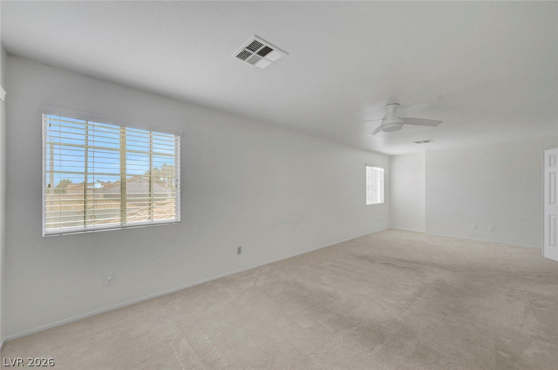 31 Antero Drive, Henderson, NV 89074 Bright windows and carpeted flooring create a comfortable and inviting atmosphere in this spacious bedroom.