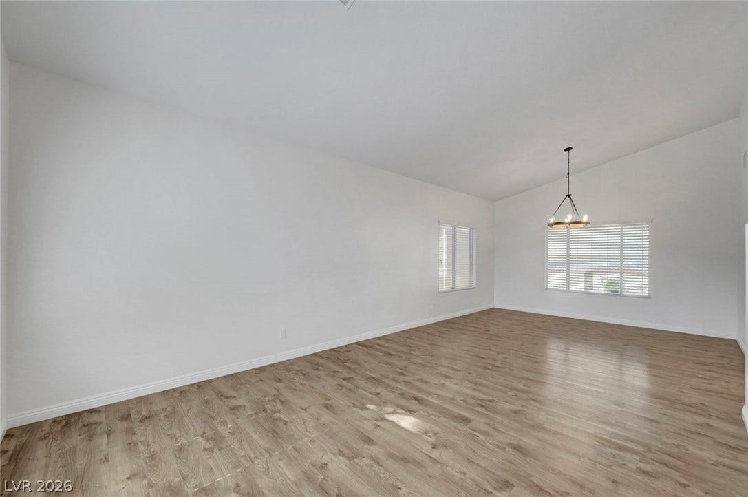 31 Antero Drive, Henderson, NV 89074 A spacious room presents natural light and vaulted ceilings, creating an open and welcoming atmosphere.