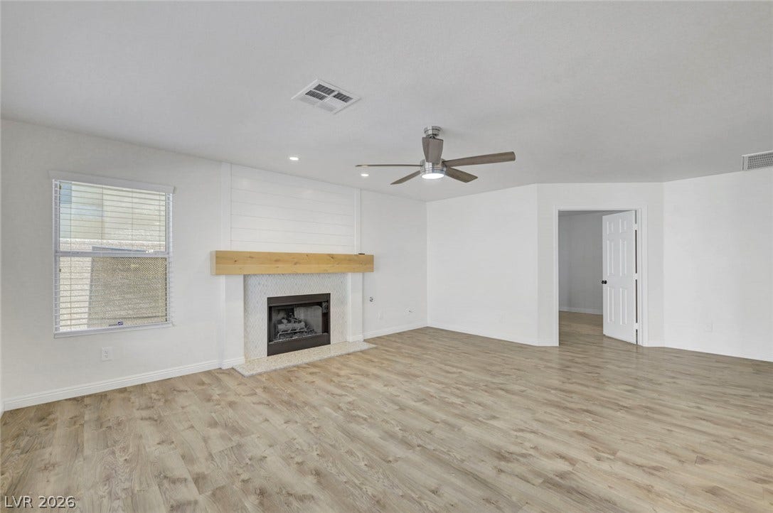 31 Antero Drive, Henderson, NV 89074 A refined fireplace and shiplap accent wall anchor this airy, naturally illuminated gathering space.