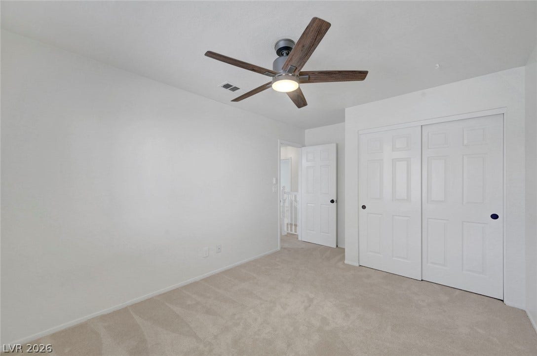 31 Antero Drive, Henderson, NV 89074 A well-lit bedroom offering a cozy carpeted floor and ample storage with sliding closet doors.