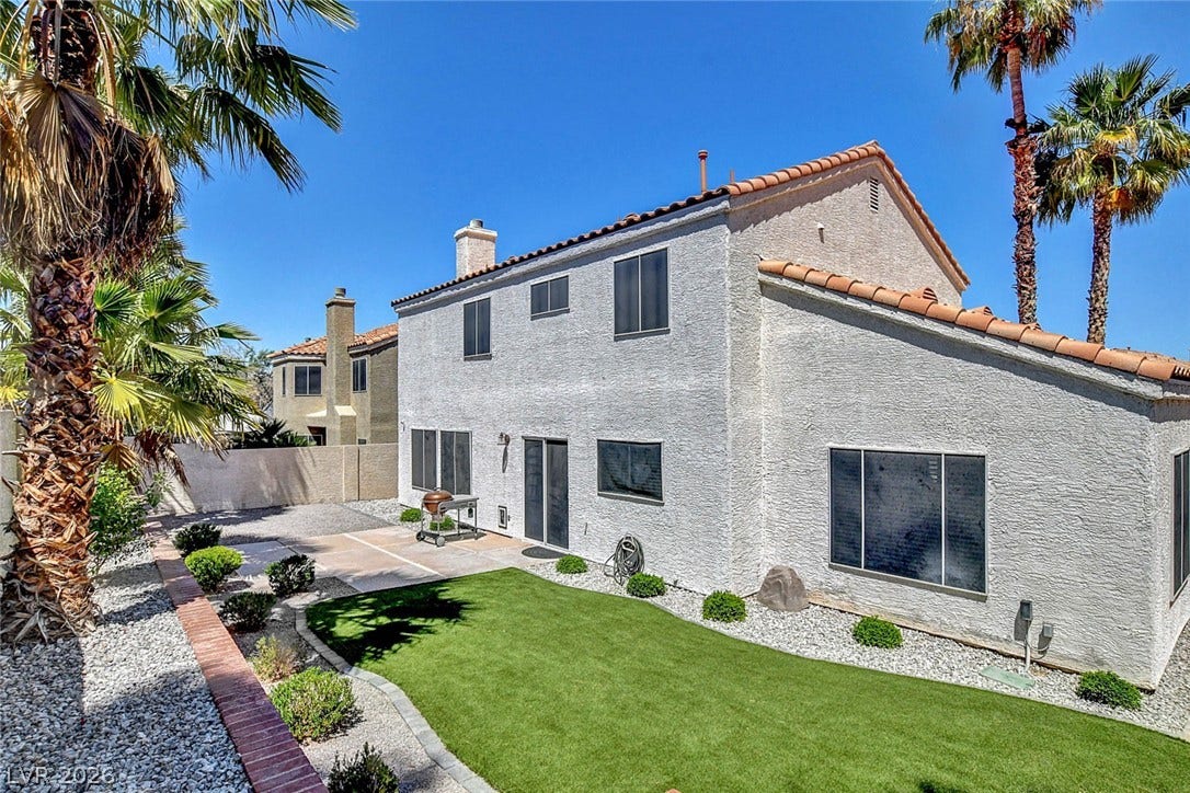 31 Antero Drive, Henderson, NV 89074 A well-maintained yard offers both a lush lawn and a practical patio area for outdoor enjoyment.