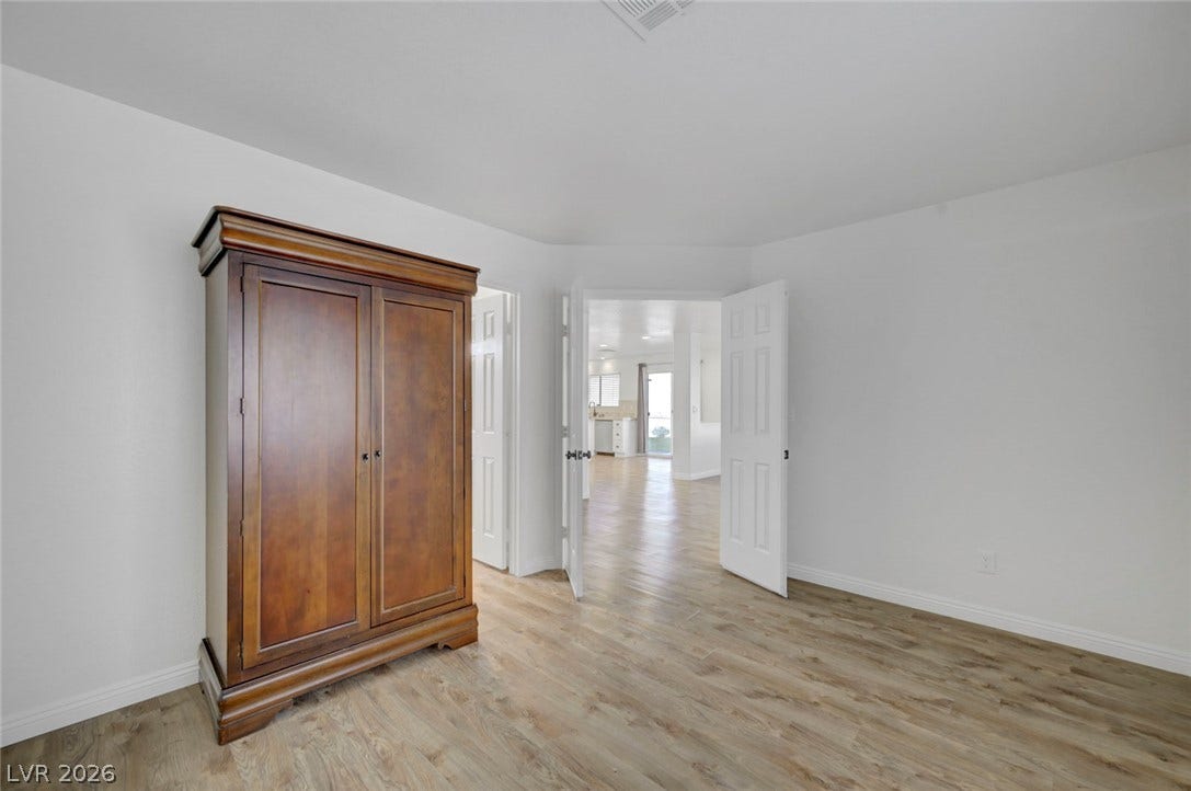 31 Antero Drive, Henderson, NV 89074 Natural wood flooring complements this generously sized room, offering a seamless flow into the adjacent living spaces.