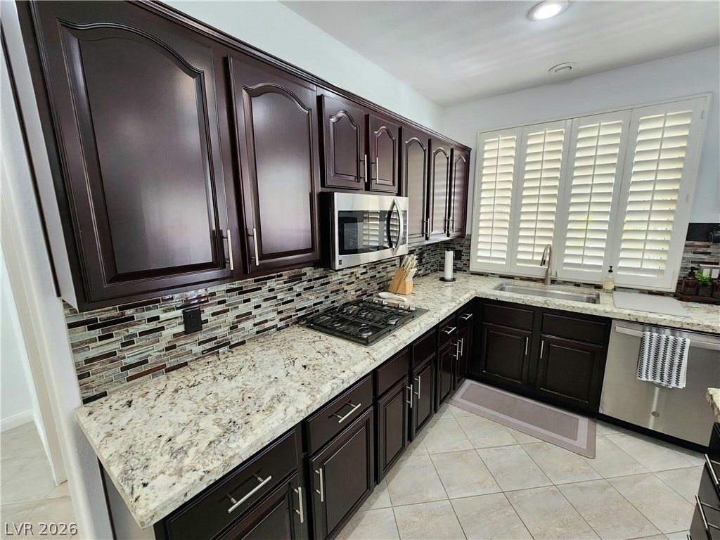 2743 Peekskill Avenue, Henderson, NV 89052 This modern kitchen features rich cabinetry, a stylish backsplash, and ample counter space for culinary creations.