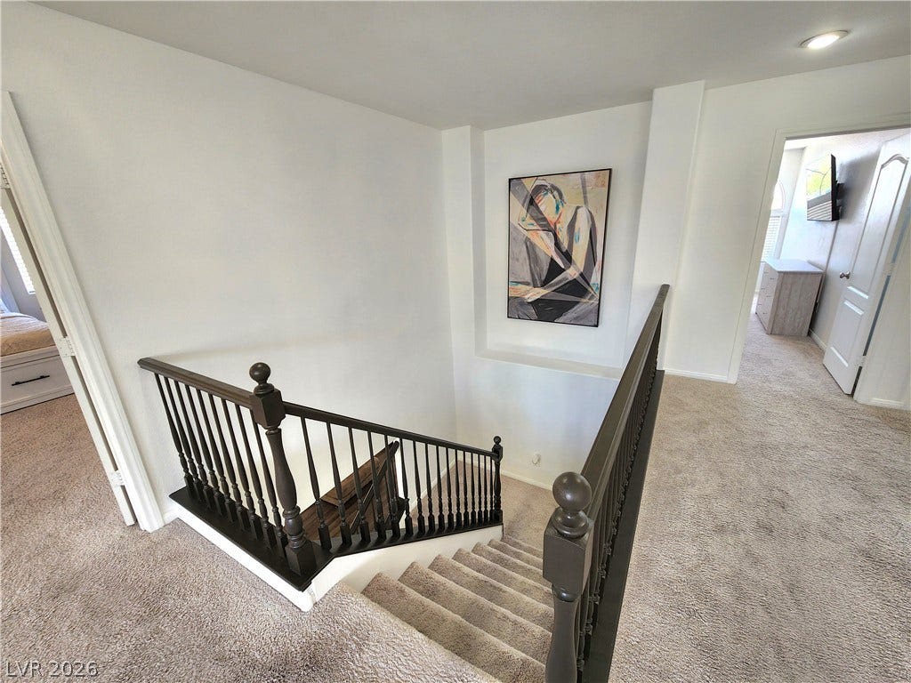 2743 Peekskill Avenue, Henderson, NV 89052 This carpeted staircase with classic banisters leads to an inviting upper level.