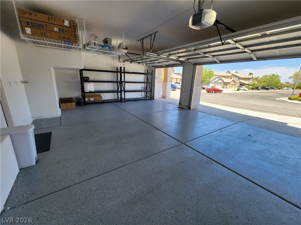 2743 Peekskill Avenue, Henderson, NV 89052 This spacious garage offers practical storage solutions with an open door to the inviting neighborhood.