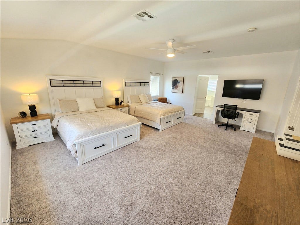2743 Peekskill Avenue, Henderson, NV 89052 Bright and airy, this spacious bedroom features plush carpeting and elegant window blinds.
