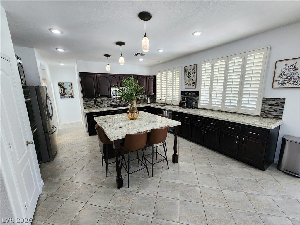 2743 Peekskill Avenue, Henderson, NV 89052 This kitchen showcases a central island and modern appliances, creating an inviting space for culinary endeavors.