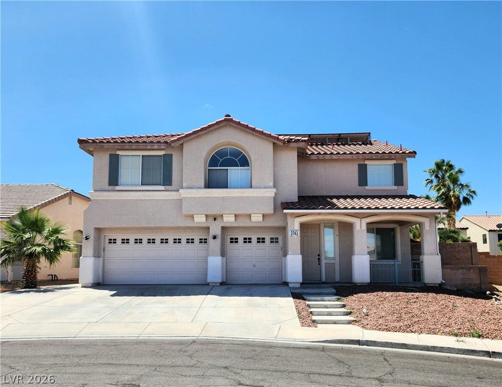 2743 Peekskill Avenue, Henderson, NV 89052 A terracotta-tiled roof crowns this residence, featuring a welcoming covered front porch and an attached garage.