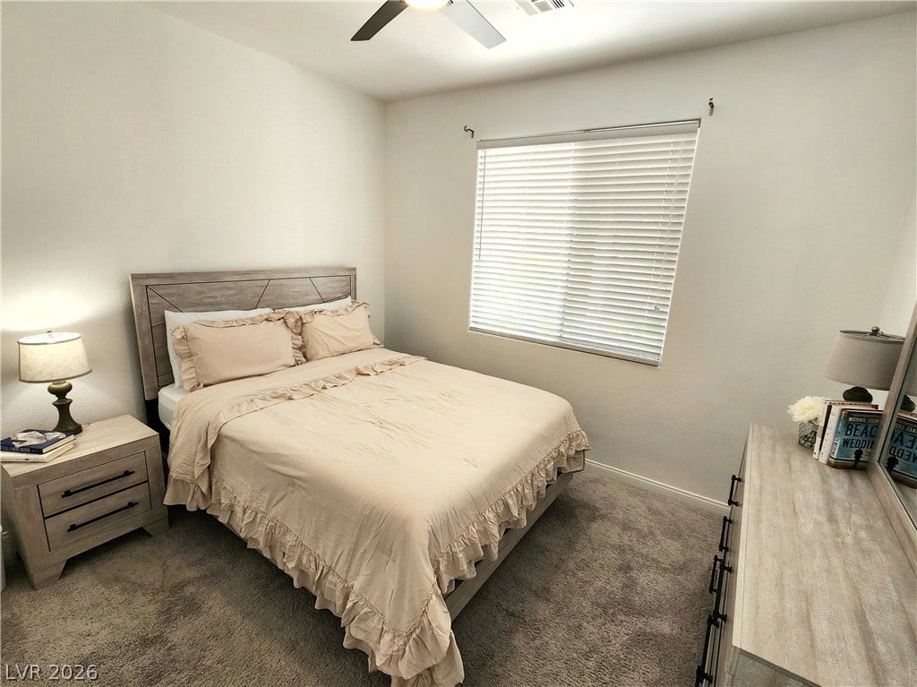 2743 Peekskill Avenue, Henderson, NV 89052 This cozy downstairs bedroom provides a comfortable retreat with soft lighting and ample space for relaxation.