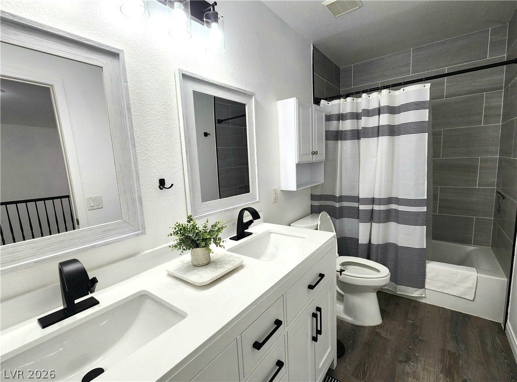 2743 Peekskill Avenue, Henderson, NV 89052 This modern bathroom offers dual vanities and a sleek tiled shower, providing comfort and contemporary style.