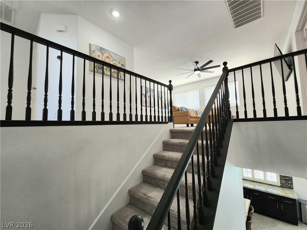 2743 Peekskill Avenue, Henderson, NV 89052 This interior staircase features carpeted steps and a dark wood banister.