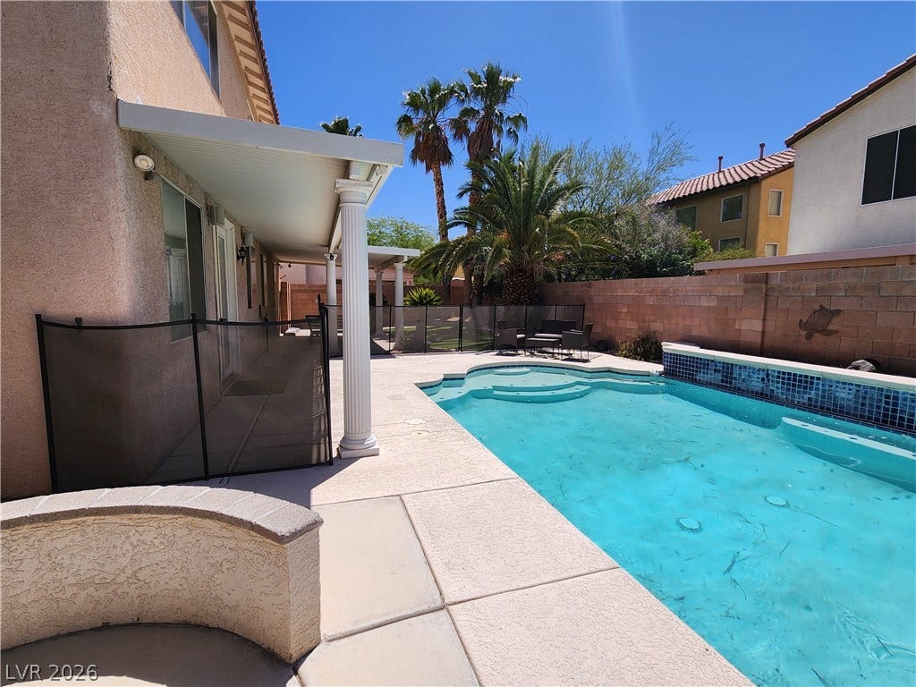 2743 Peekskill Avenue, Henderson, NV 89052 This outdoor oasis features a refreshing pool, inviting patio, and lush palm trees.