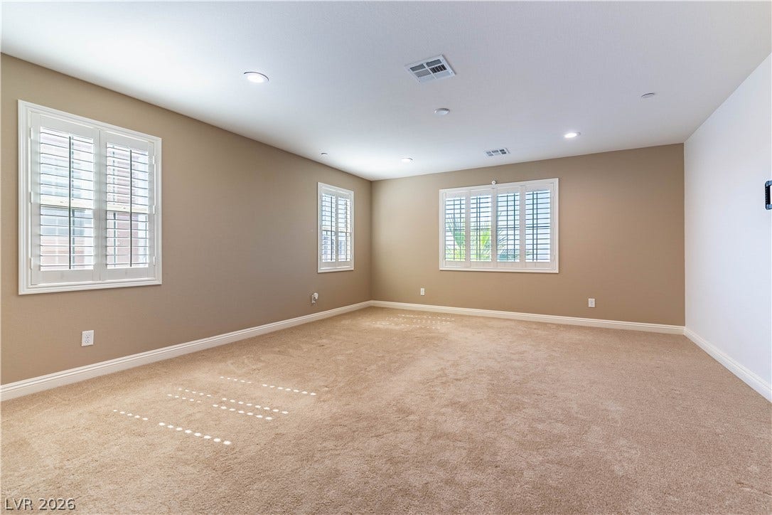 900 San Laurent Court, Henderson, NV 89012 Two windows with plantation shutters allow ample natural light into this adaptable bedroom space.