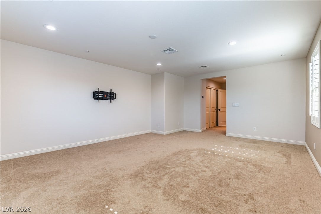 900 San Laurent Court, Henderson, NV 89012 A versatile open space with soft carpeting and bright recessed lighting awaits your personal touch.