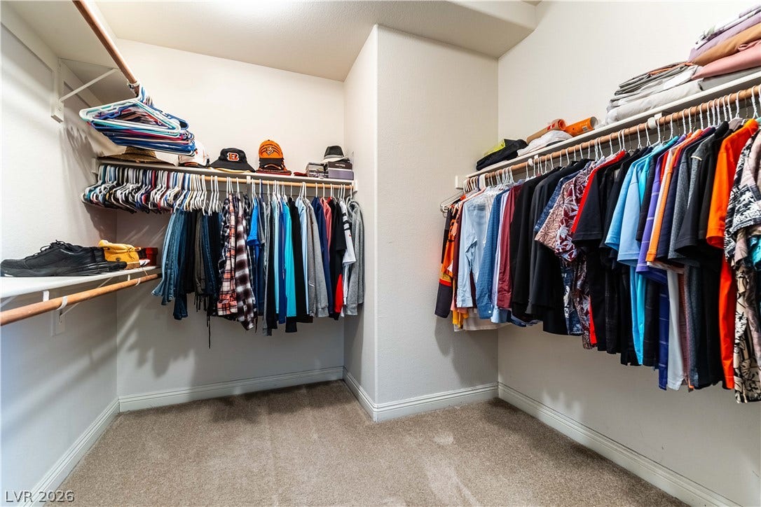 900 San Laurent Court, Henderson, NV 89012 A well-organized primary closet offers ample shelving and hanging space for an extensive wardrobe.