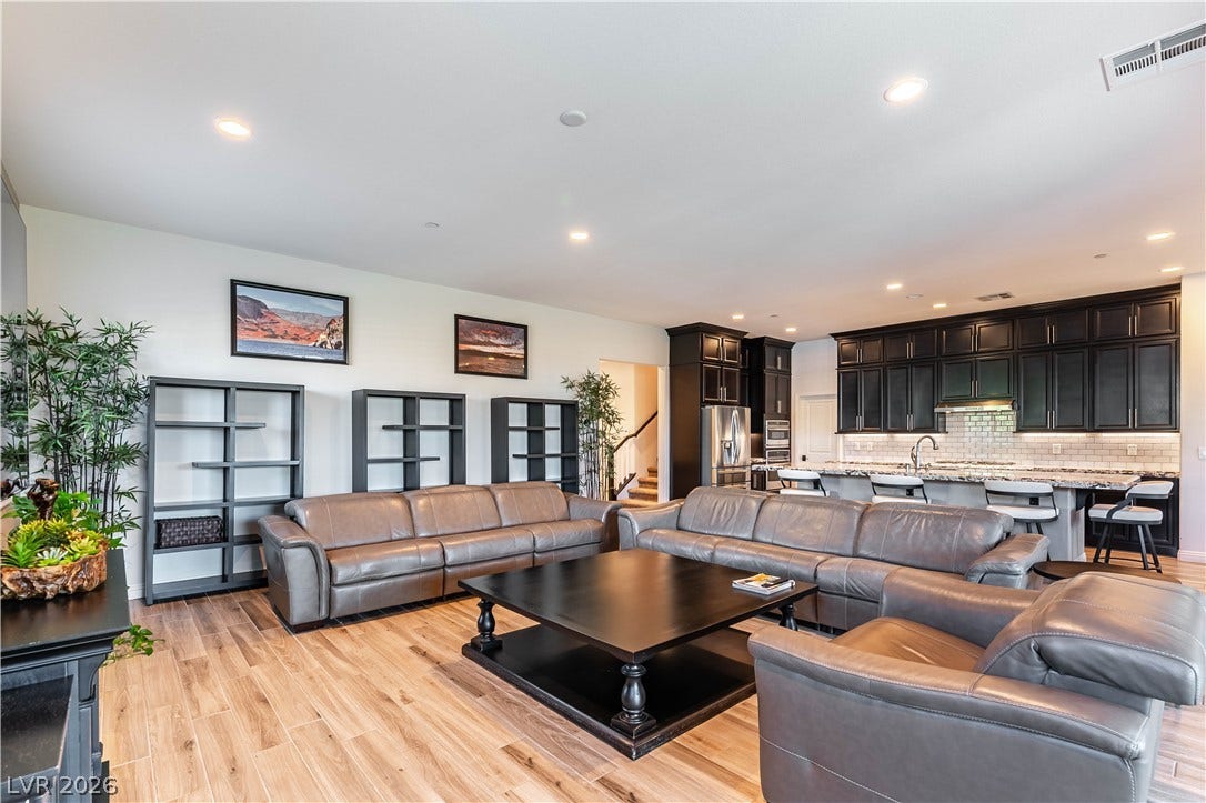 900 San Laurent Court, Henderson, NV 89012 A well-lit open-concept living area boasts abundant seating and flows seamlessly into a contemporary kitchen.