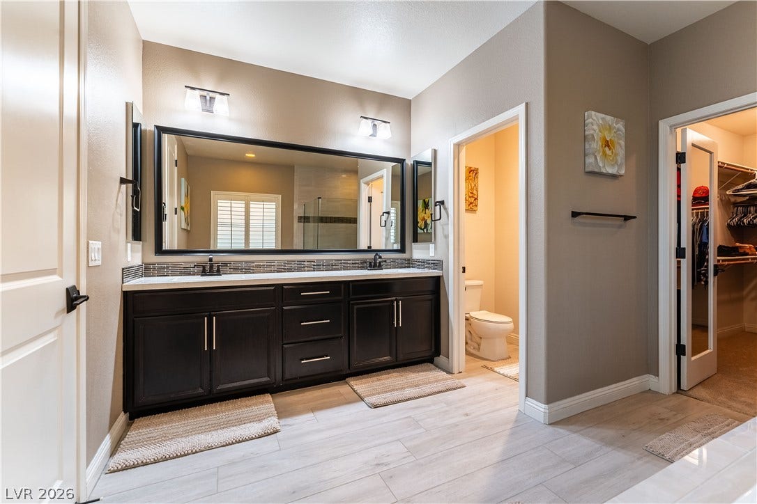 900 San Laurent Court, Henderson, NV 89012 A well-appointed bath boasts dual vanities and light flooring, ready for daily routines.