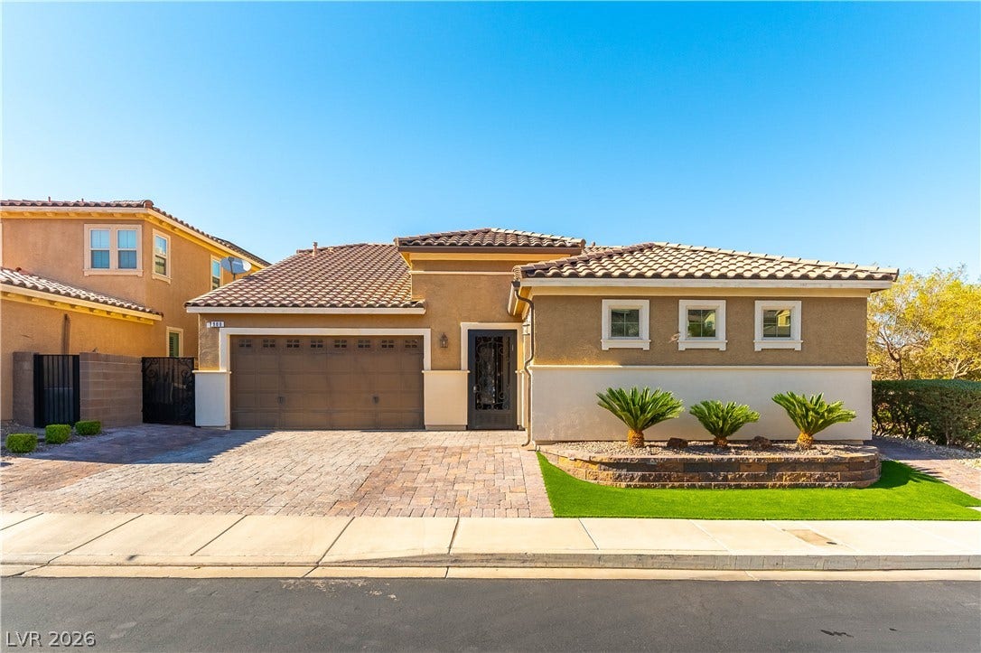 900 San Laurent Court, Henderson, NV 89012 A well-maintained stucco facade with a tiled roof presents a welcoming curb appeal.