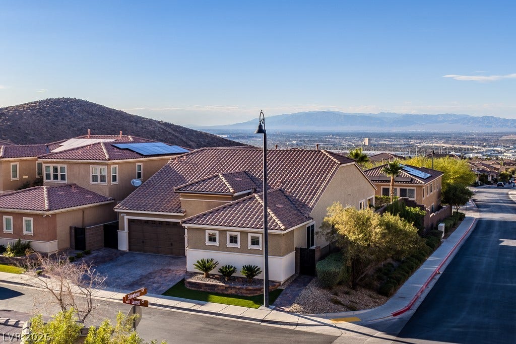 900 San Laurent Court, Henderson, NV 89012 Perched on a hillside, this residence offers a captivating panoramic view of the distant cityscape and mountain ranges.