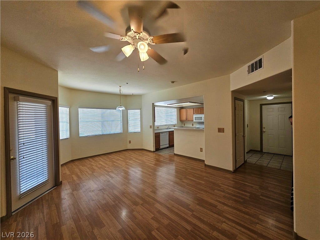 833 Aspen Peak Loop, #112, Henderson, NV 89011 An inviting open living space features warm wood laminate flooring and ceiling fan
