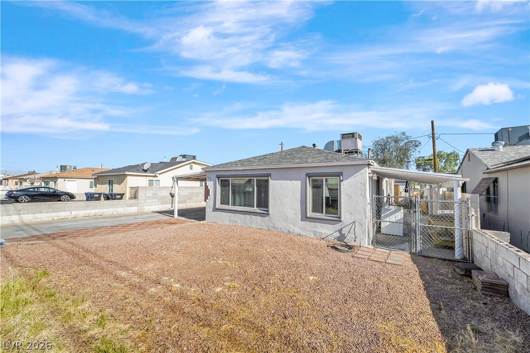 A modest single-story residence with a practical carport, perfect for comfortable living.