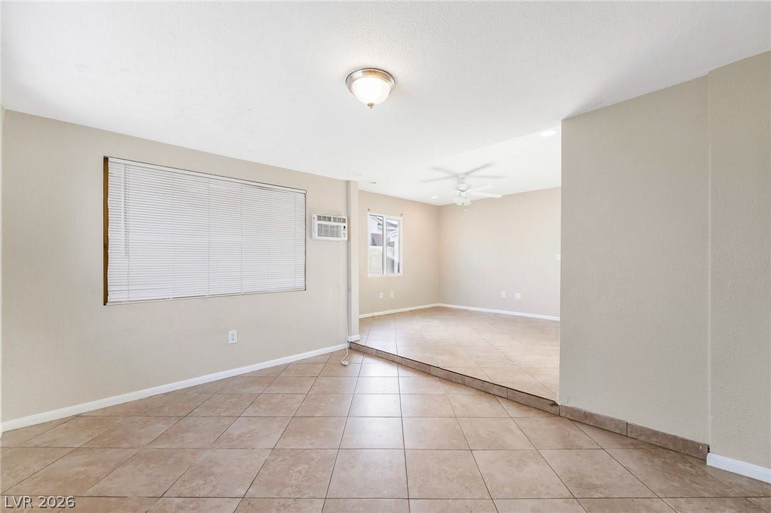 Step into this spacious room featuring versatile tiled flooring and ample natural light.