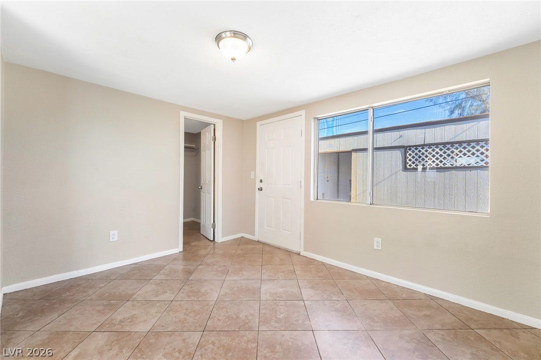 Functional room features durable tile flooring, providing a versatile living space.