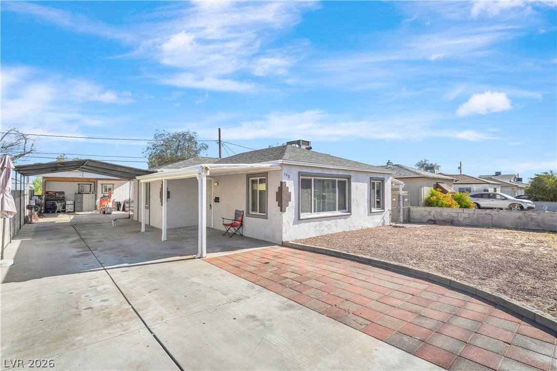 A well-maintained facade with a covered carport provides ample parking and a welcoming entry.