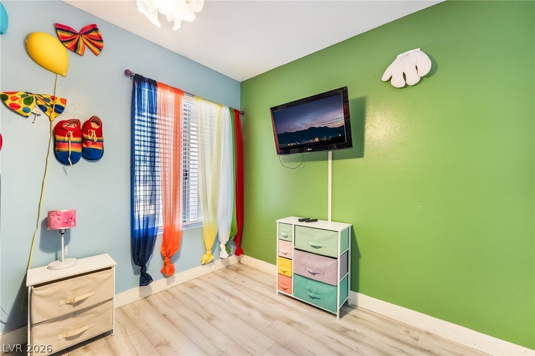 3111 Belvedere Drive, Henderson, NV 89014 Natural light streams into this cheerful bedroom, featuring sleek hardwood flooring.
