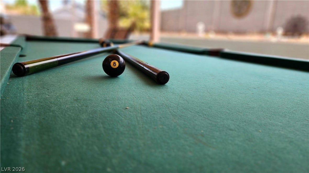 3111 Belvedere Drive, Henderson, NV 89014 An inviting game room features a well-maintained billiards table, perfect for leisure and entertainment.