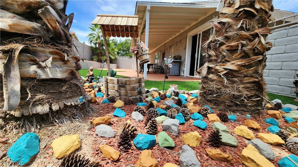 3111 Belvedere Drive, Henderson, NV 89014 A charming covered patio and lush lawn define this private, landscaped backyard oasis.