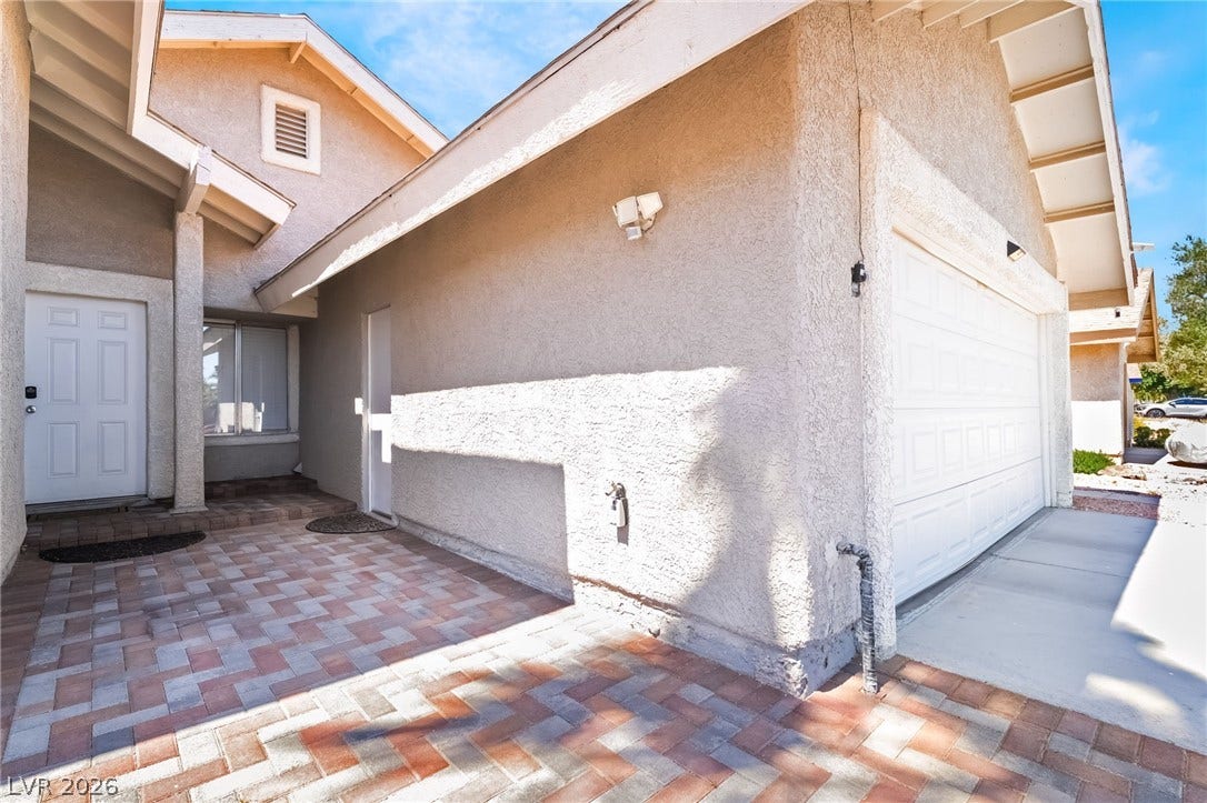 3111 Belvedere Drive, Henderson, NV 89014 A welcoming paver walkway leads to the entrance of this charming residence, featuring an attached garage.