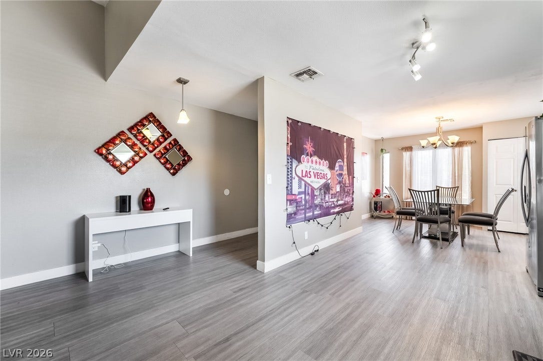 3111 Belvedere Drive, Henderson, NV 89014 Clean lines and a light wood-look floor define this inviting living and dining space.