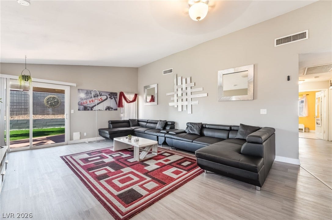 3111 Belvedere Drive, Henderson, NV 89014 Sliding doors invite outdoor access, complementing this living room's light wood flooring.