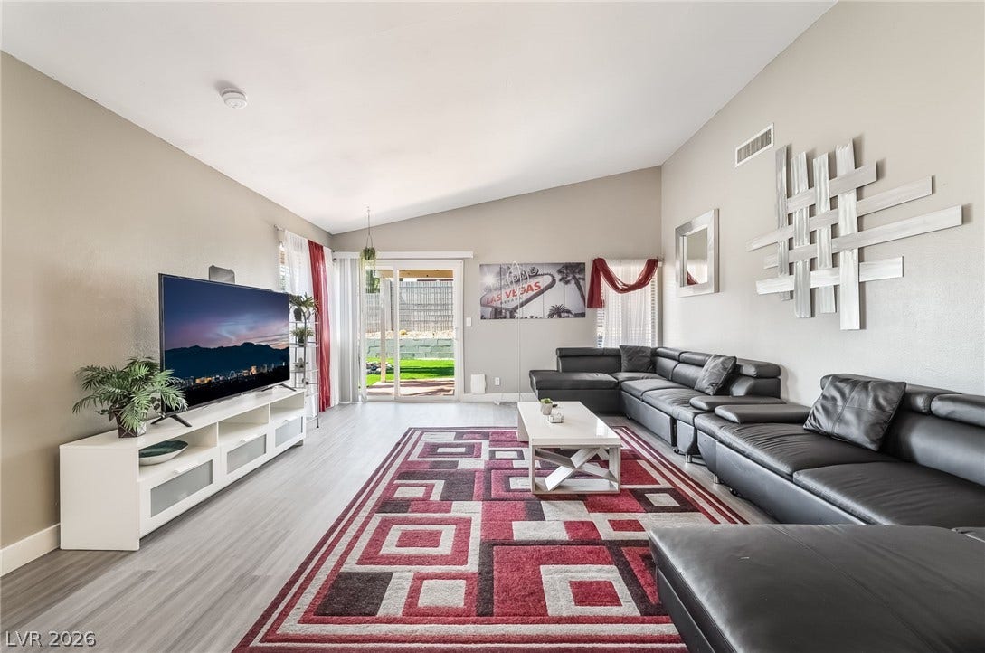 3111 Belvedere Drive, Henderson, NV 89014 Vast vaulted ceilings complement an inviting living area with a sliding door leading to the yard.