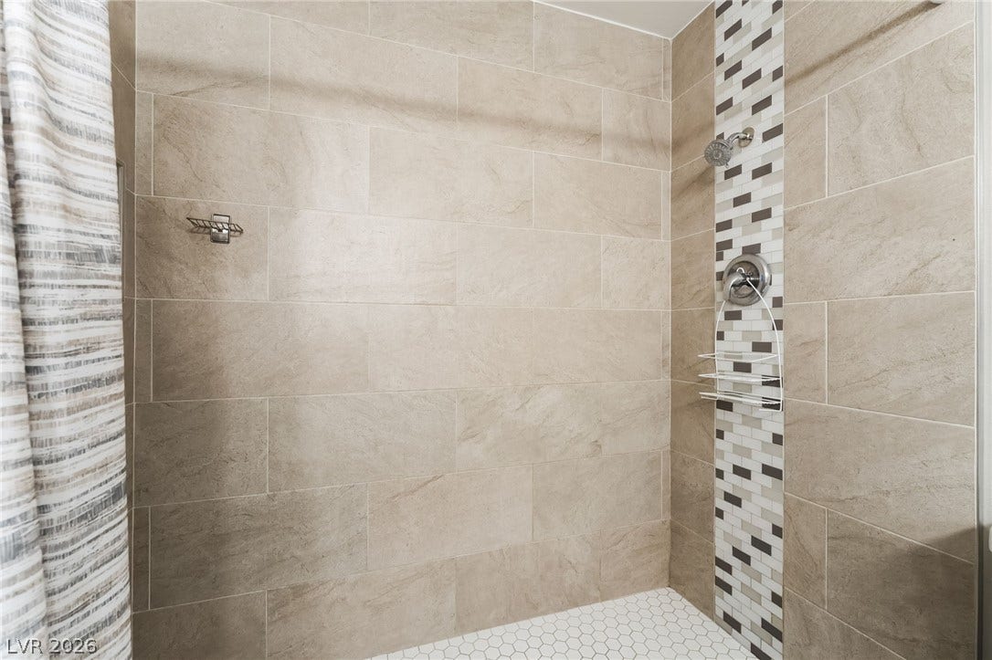 3111 Belvedere Drive, Henderson, NV 89014 Step into this contemporary shower featuring sleek tiled walls and a mosaic accent strip.