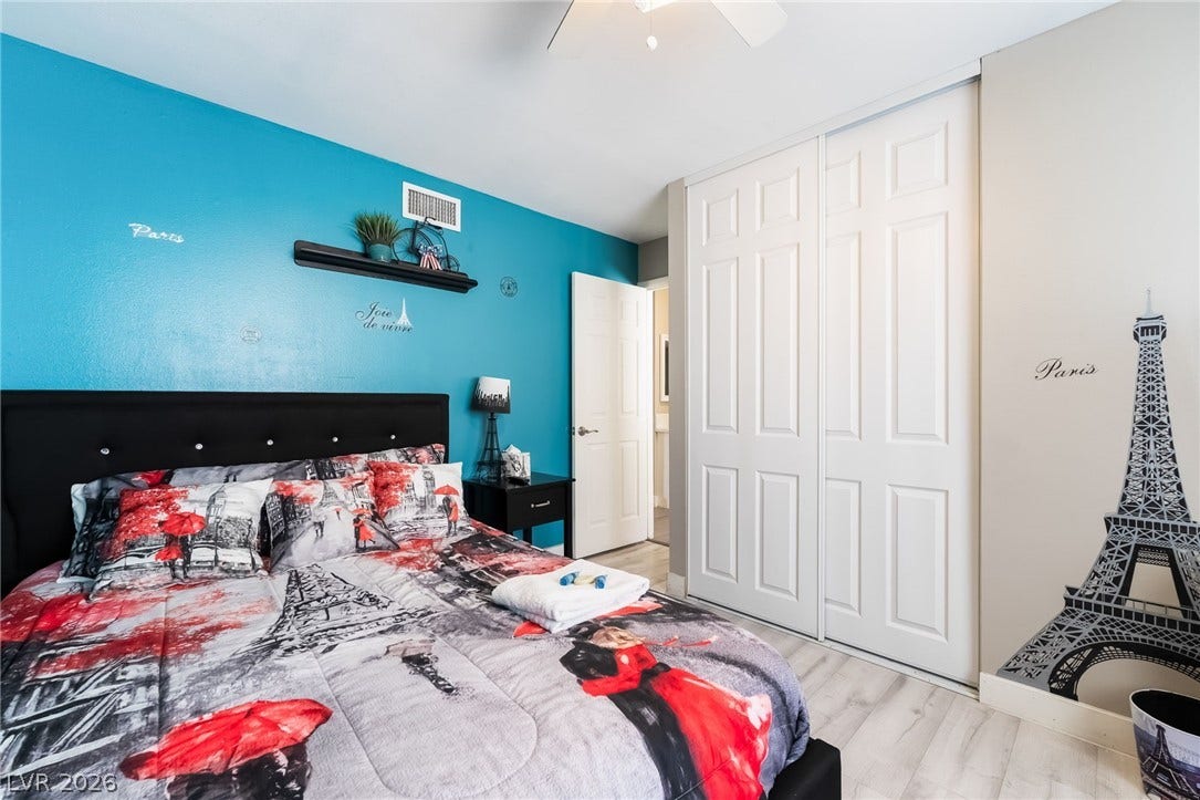 3111 Belvedere Drive, Henderson, NV 89014 A well-lit bedroom features a vibrant accent wall and ample storage.