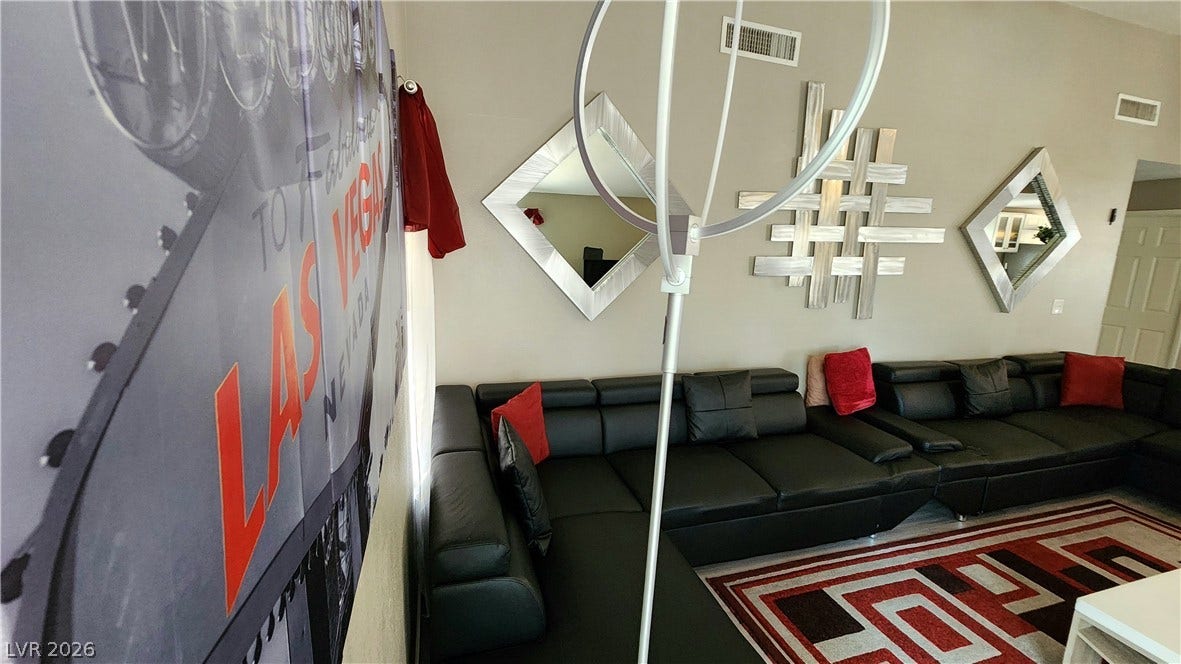 3111 Belvedere Drive, Henderson, NV 89014 A well-appointed living area features a plush sectional sofa, perfect for comfortable lounging and entertaining.