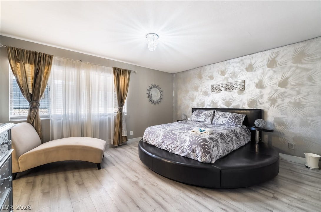 3111 Belvedere Drive, Henderson, NV 89014 Well-lit sleeping quarters with elegant window treatments and durable flooring, perfect for relaxation.